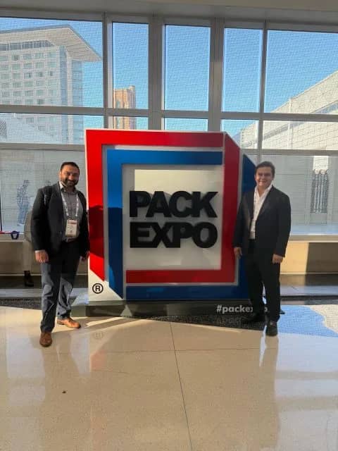 Multi Trade Group representatives beside the PACK EXPO display