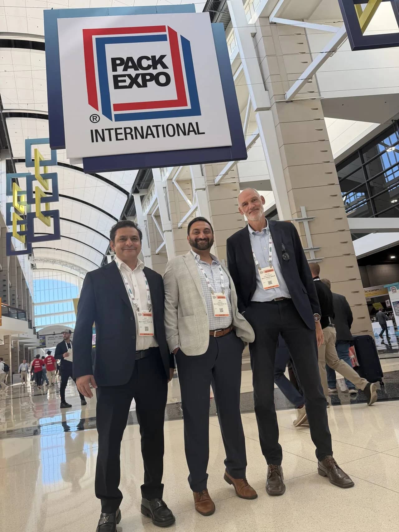 Multi Trade Group team beneath the PACK EXPO International sign in Chicago