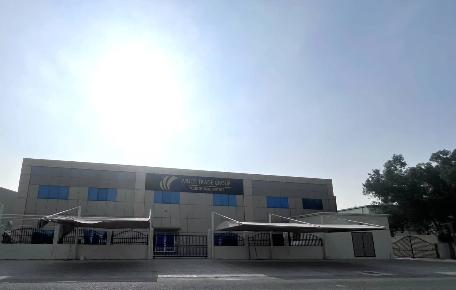 Front view of Multi Trade Group's UAE facility with company signage and gated entrance