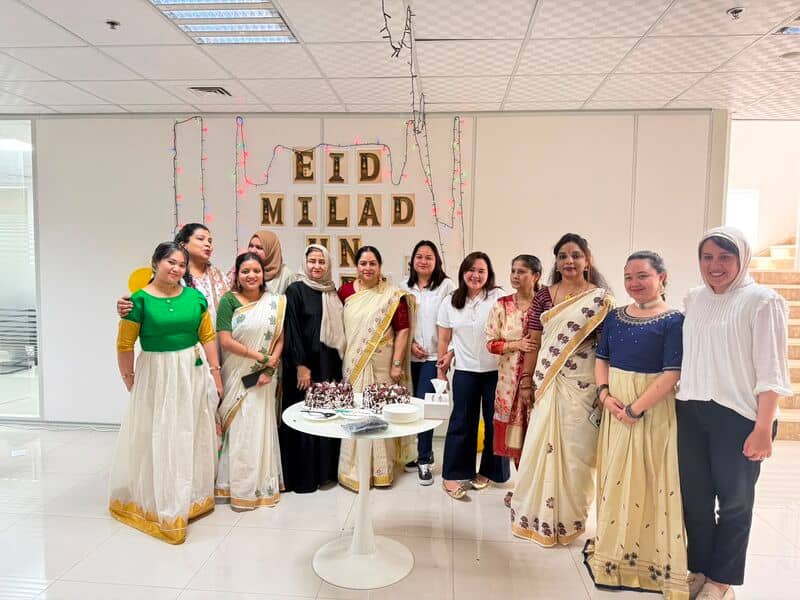 Colleagues sharing the Eid Milad-un-Nabi celebration
